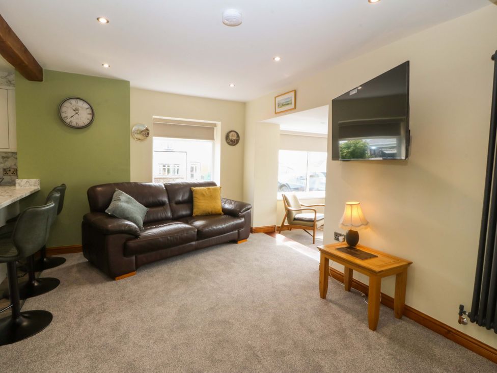 A living room with a sofa and television at Dalar Deg Aberdaron