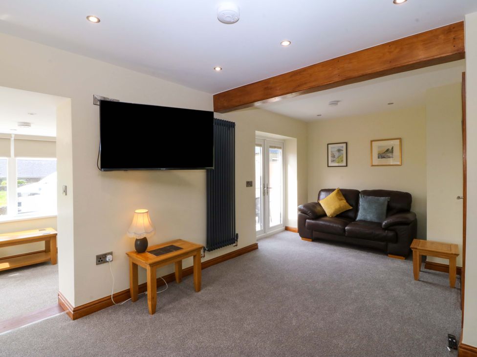 A living room with a sofa and television at Dalar Deg Aberdaron
