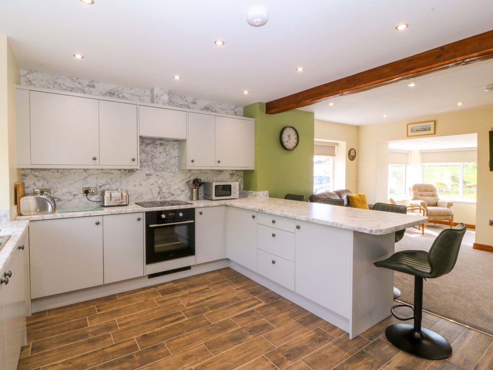 A kitchen with cabinets and countertop at Dalar Deg in Aberdaron