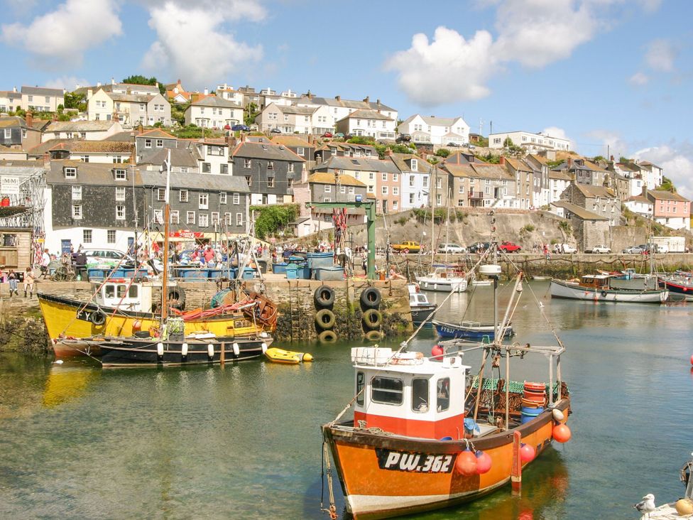A harbor with boats and buildings at Captain's Cabin in Mevagissey