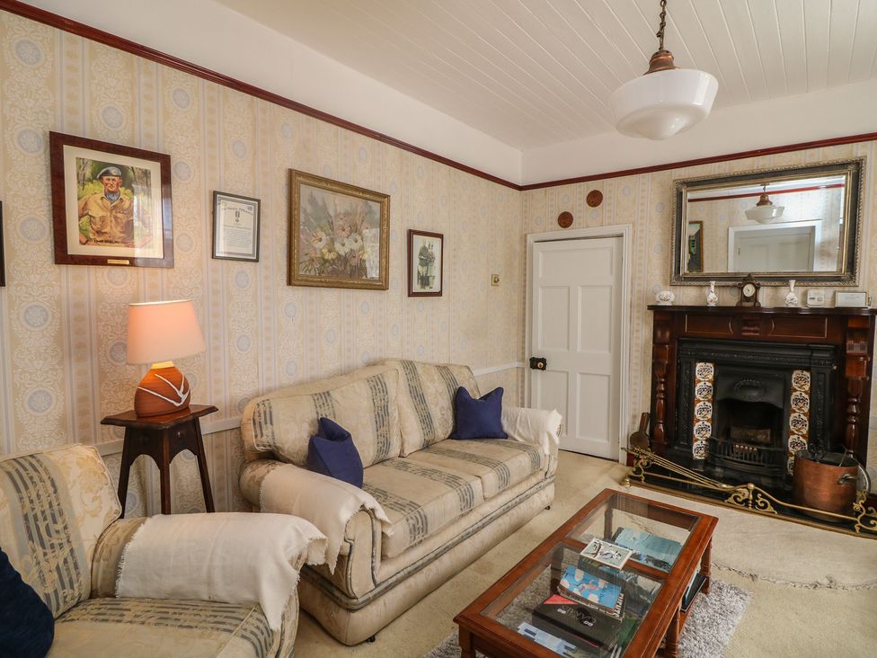 A living room with furniture and wall art at Cairbre House in Dungarvan, County Waterford