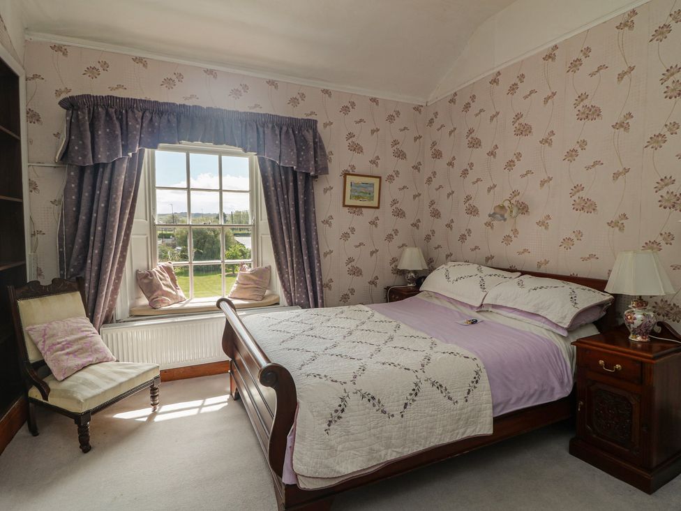 A bedroom with a bed and window at Cairbre House, Dungarvan, County Waterford