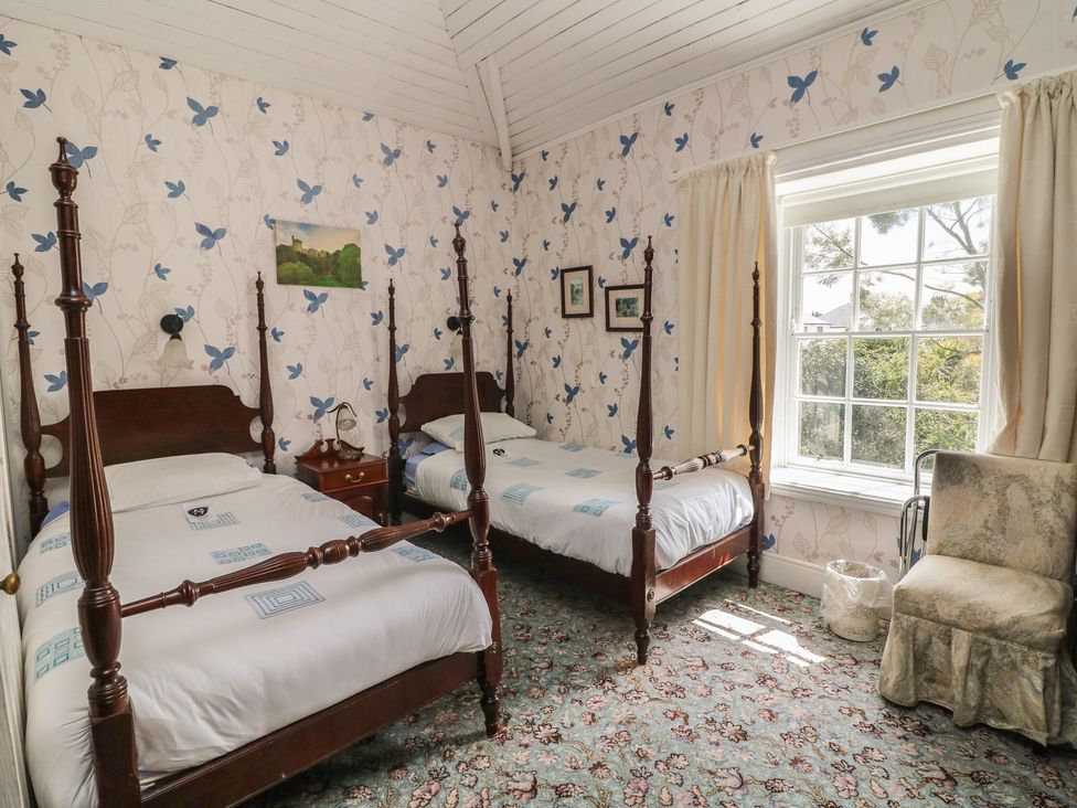 A bedroom with two beds and a window at Cairbre House in Dungarvan, County Waterford