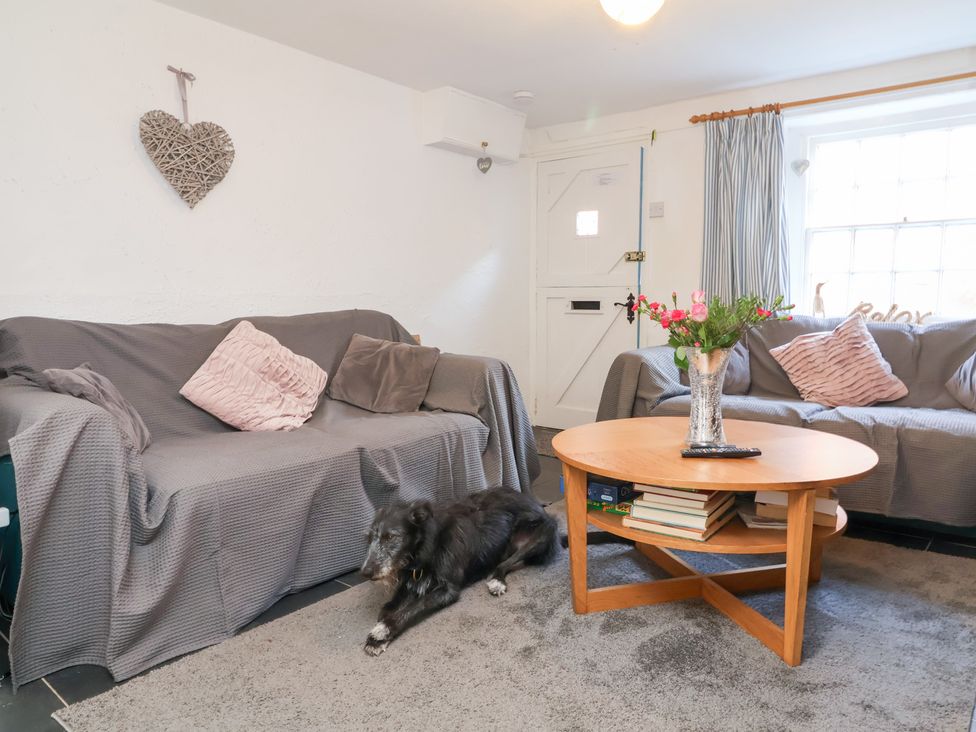 A living room with sofas and a coffee table at Willets Cottage in Appledore