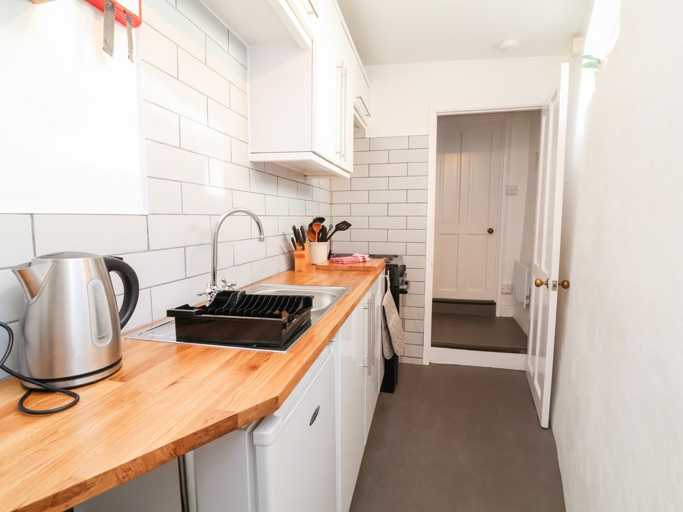A kitchen with a sink and kettle at Willets Cottage Appledore