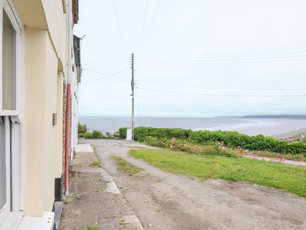 An outdoor area with a view of the sea and path at Cecily Cottage in Westward Ho!