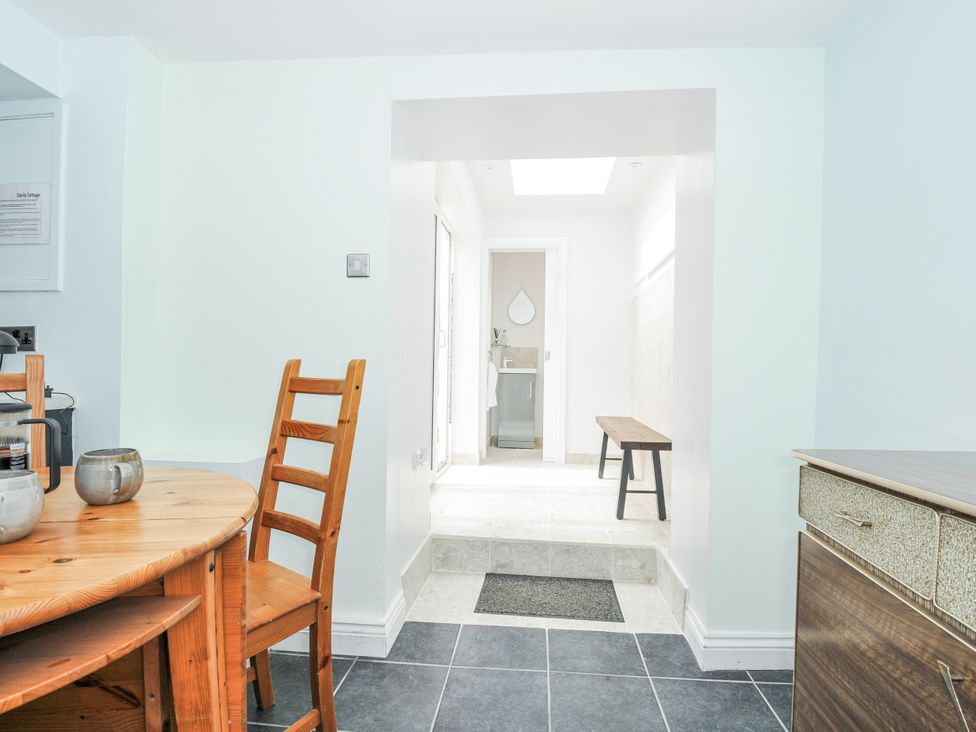 A kitchen with a table and chairs at Cecily Cottage Westward Ho!