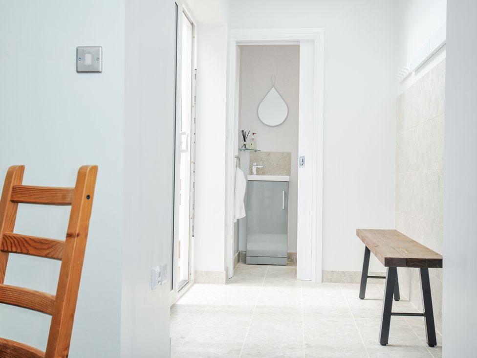 A bathroom with a sink and mirror at Cecily Cottage Westward Ho!