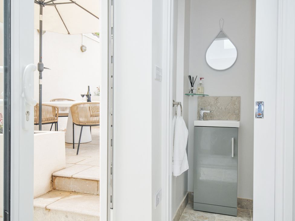 A bathroom with a sink and towel holder at Cecily Cottage in Westward Ho!