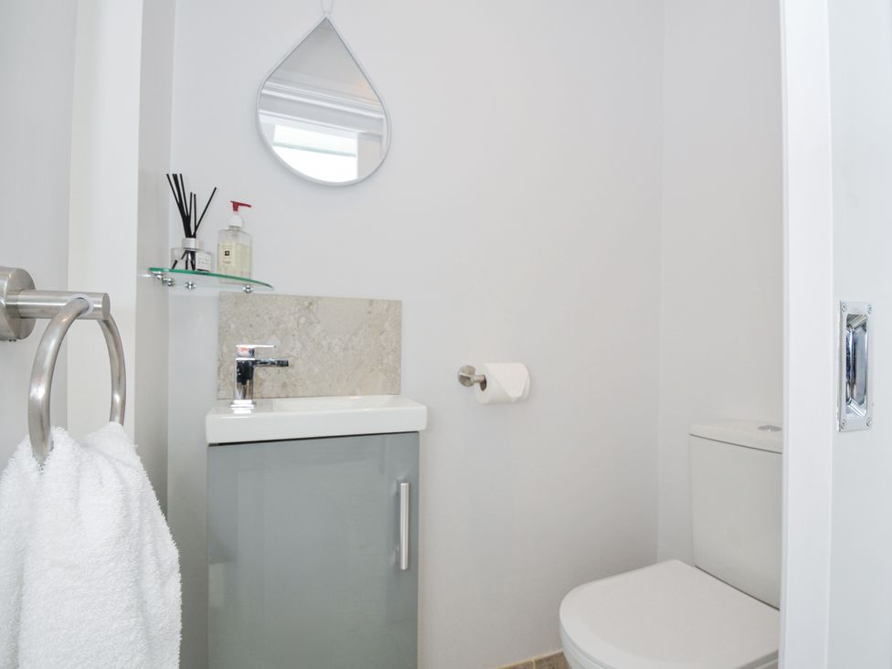 A bathroom with a sink and toilet at Cecily Cottage Westward Ho!