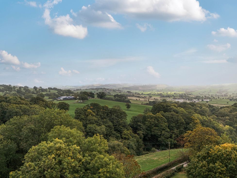 A landscape view of fields and trees at Ty Berllan in Caersws