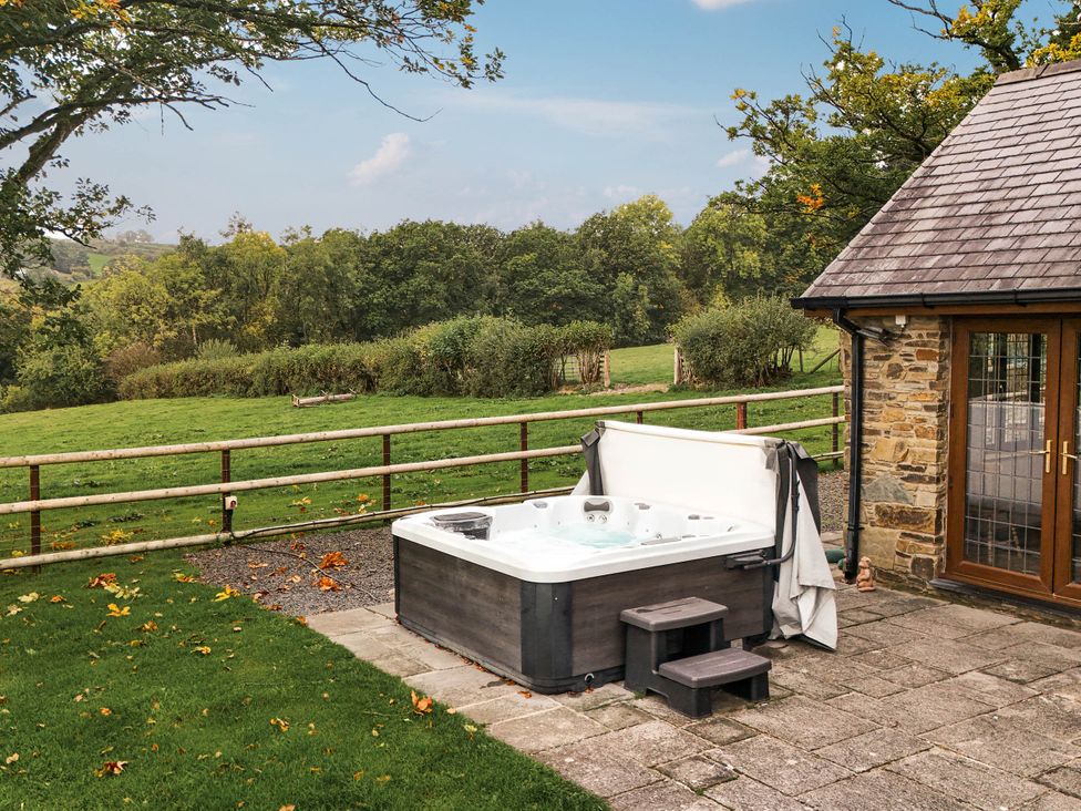 An outdoor area with a hot tub and steps at Ty Berllan in Caersws