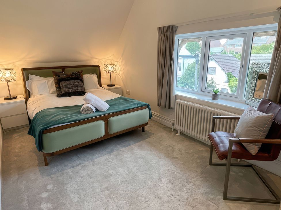 A bedroom with a bed and side table at Cliffhanger in Hastings