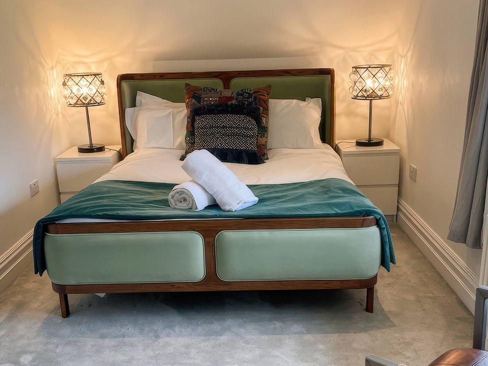 A bedroom with a bed and bedside tables at Cliffhanger in Hastings