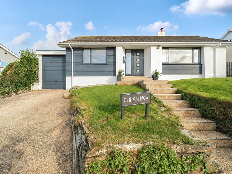 A house with a garage and steps at Chi An Mor Porth
