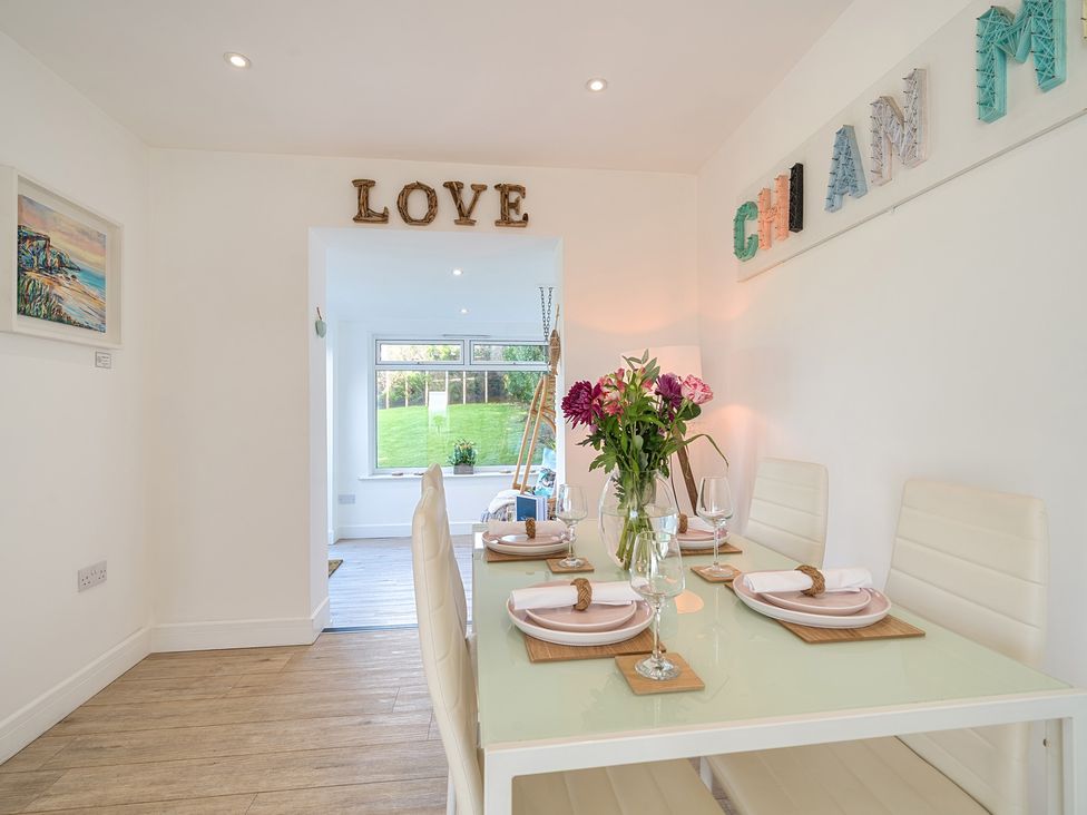 A dining room with a table set for dinner at Chi An Mor in Porth