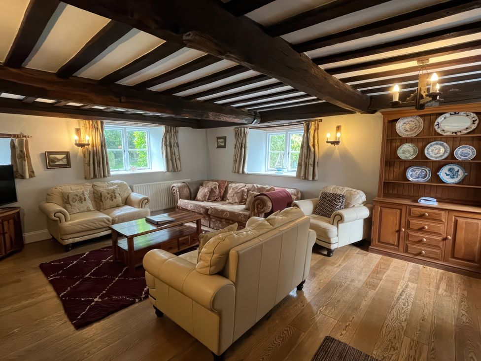 A living room with sofas and a coffee table at Ivy Cottage in West Lulworth