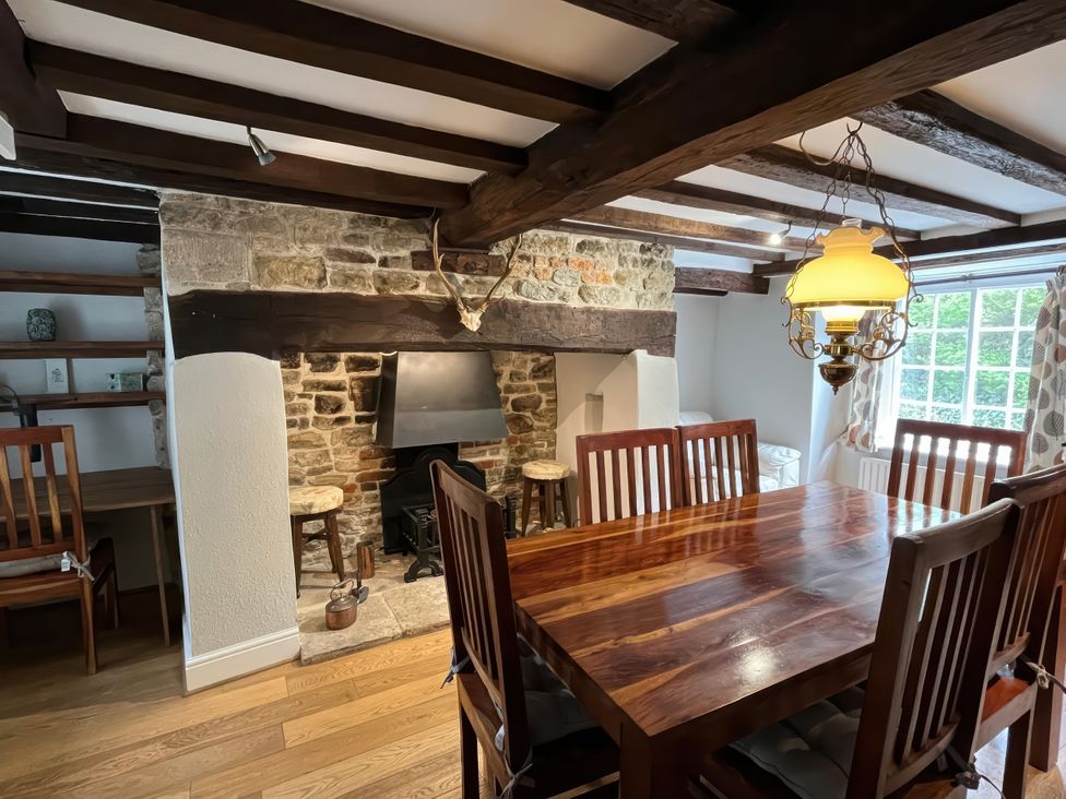 A dining room with table and chairs at Ivy Cottage in West Lulworth
