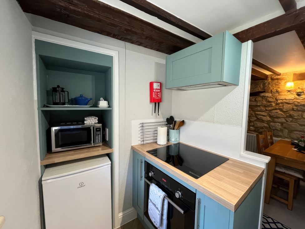 A kitchen with a microwave and mini fridge at Little Ivy in West Lulworth