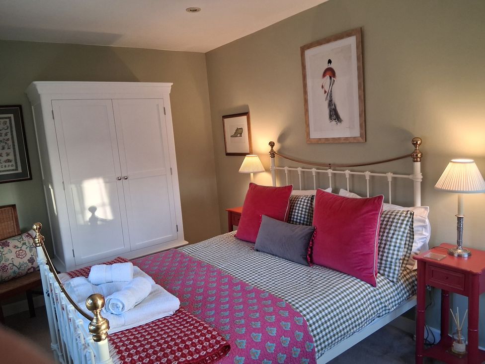 A bedroom with a bed and wardrobe at Little Retreat in Upwey