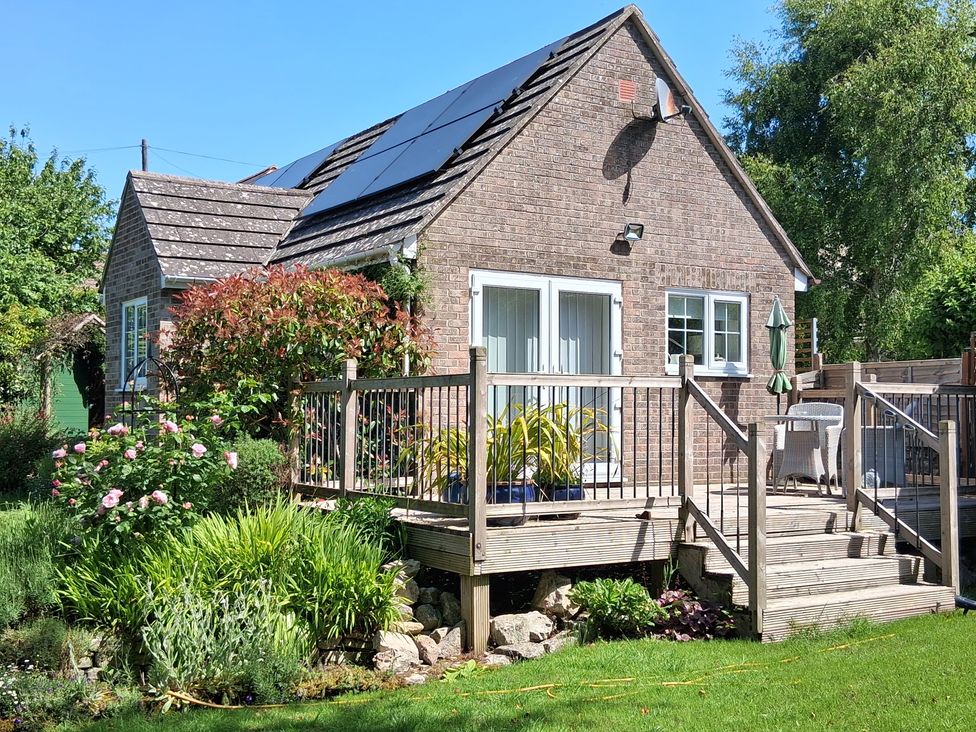A house with a deck and garden at Little Retreat in Upwey