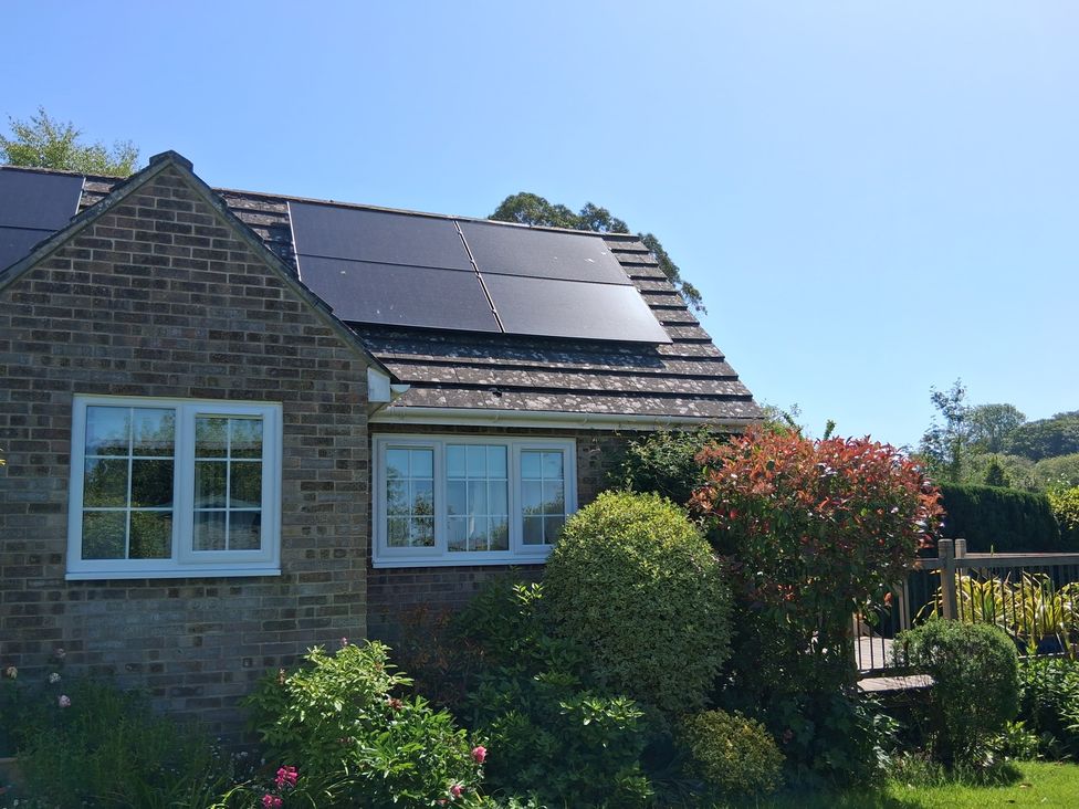 A house with solar panels and a garden at Little Retreat Upwey