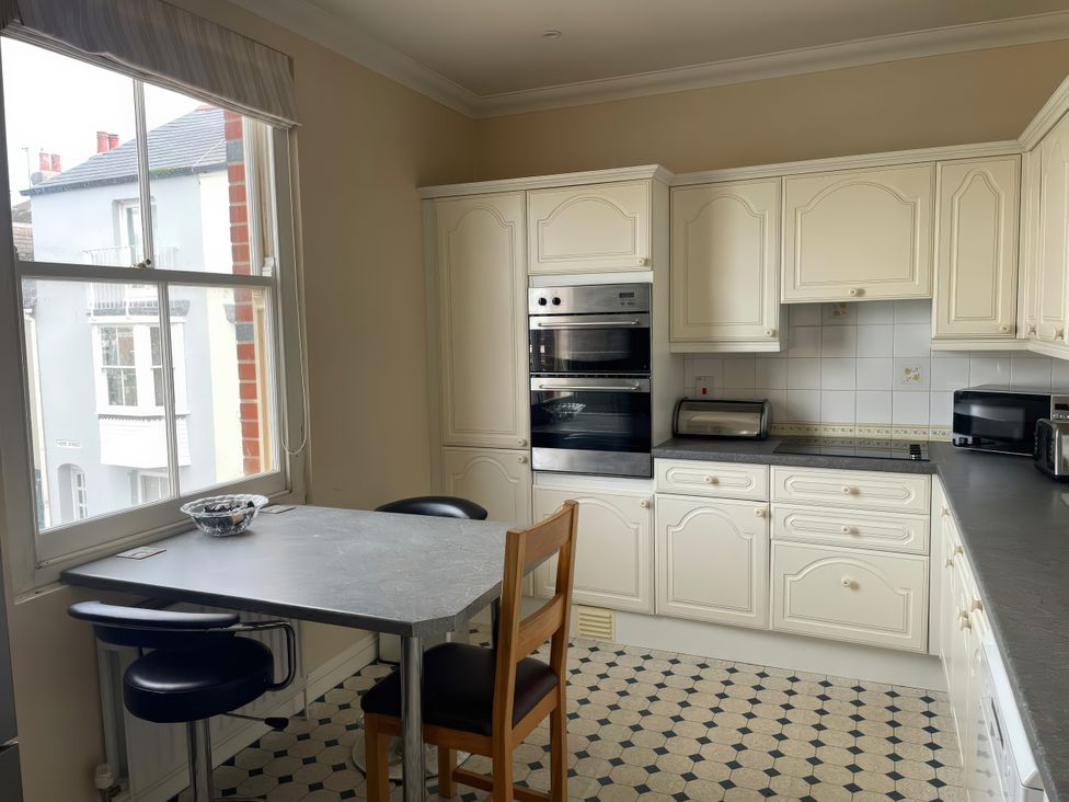 A kitchen with a table and chairs at Mutiny House in Brewers Quay Harbour