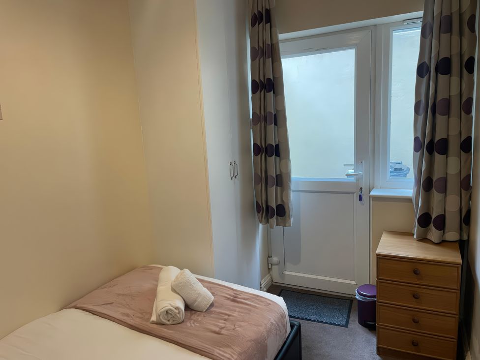 A bedroom with a bed and a door at Mutiny House Brewers Quay Harbour