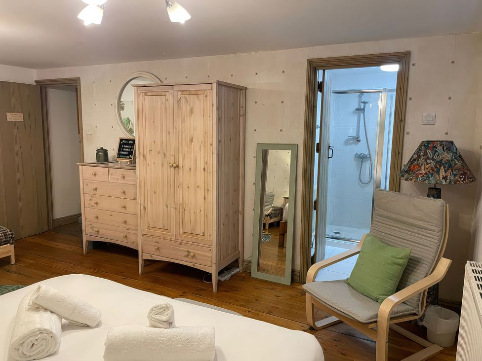 A bedroom with a wardrobe and chest of drawers at The Oast House in Brewers Quay Harbour