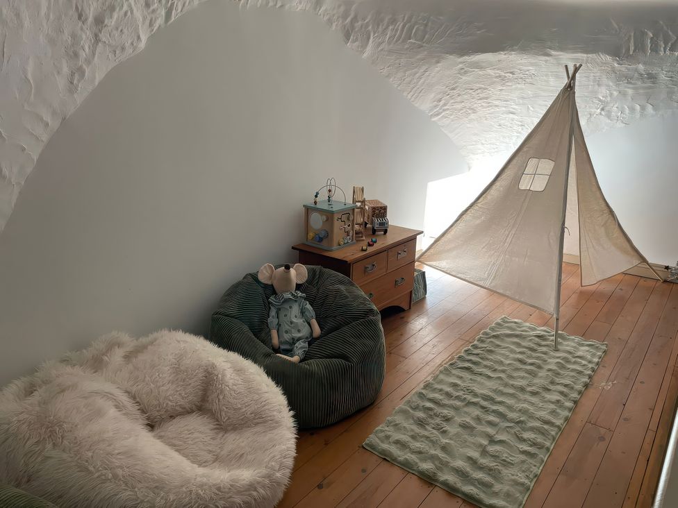 A playroom with a bean bag chair and a tent at The Oast House in Brewers Quay Harbour