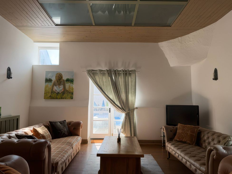 A living room with a sofa and coffee table at The Oast House in Brewers Quay Harbour