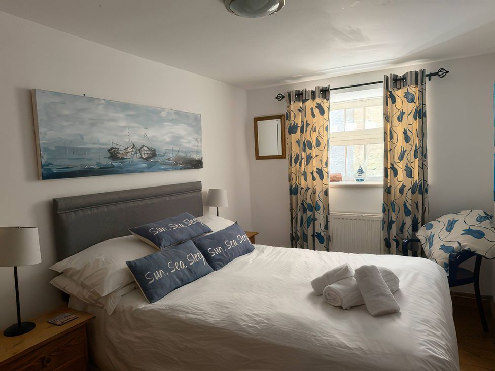 A bedroom with a bed and bedside table at The Oast House in Brewers Quay Harbour