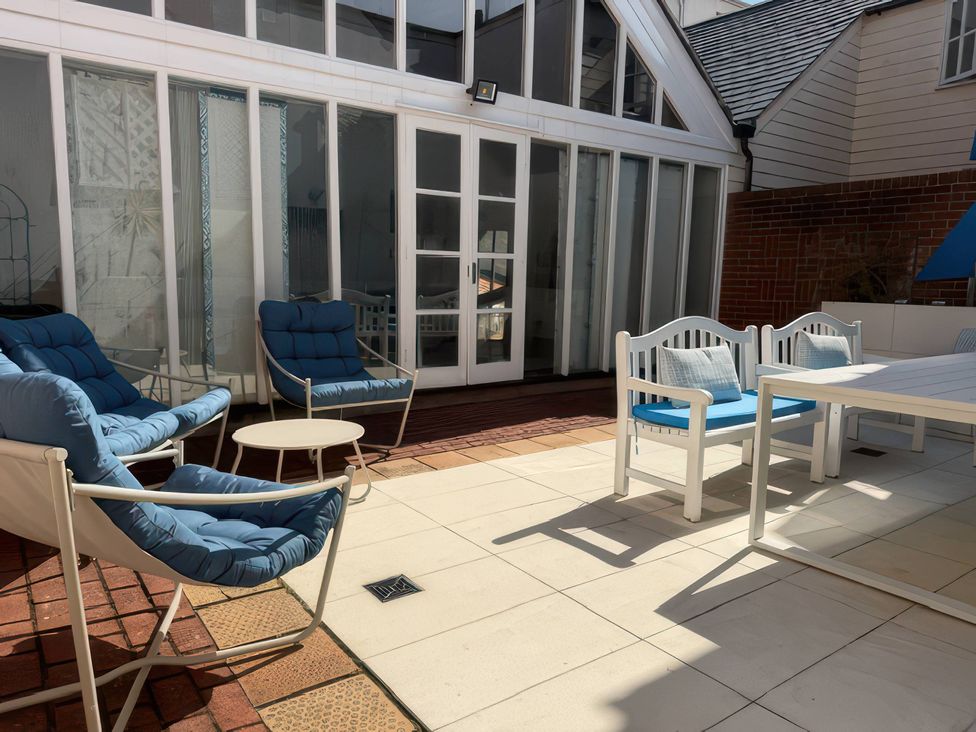 A patio with chairs and a table at The Oast House Brewers Quay Harbour