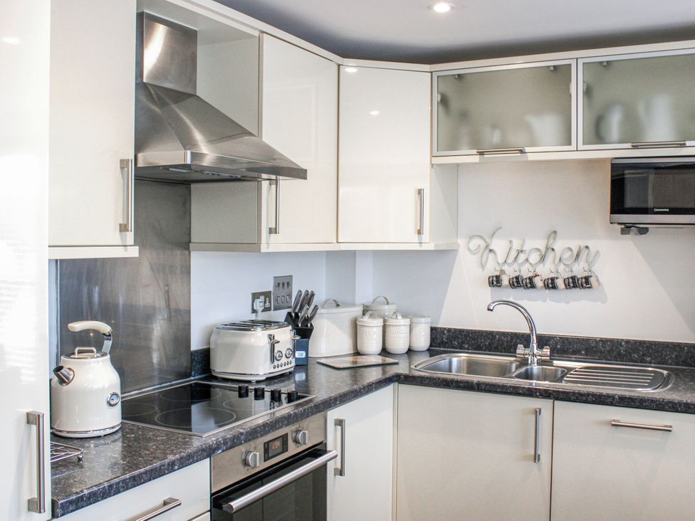 A kitchen with appliances and utensils at Estuary View in Kingsbridge
