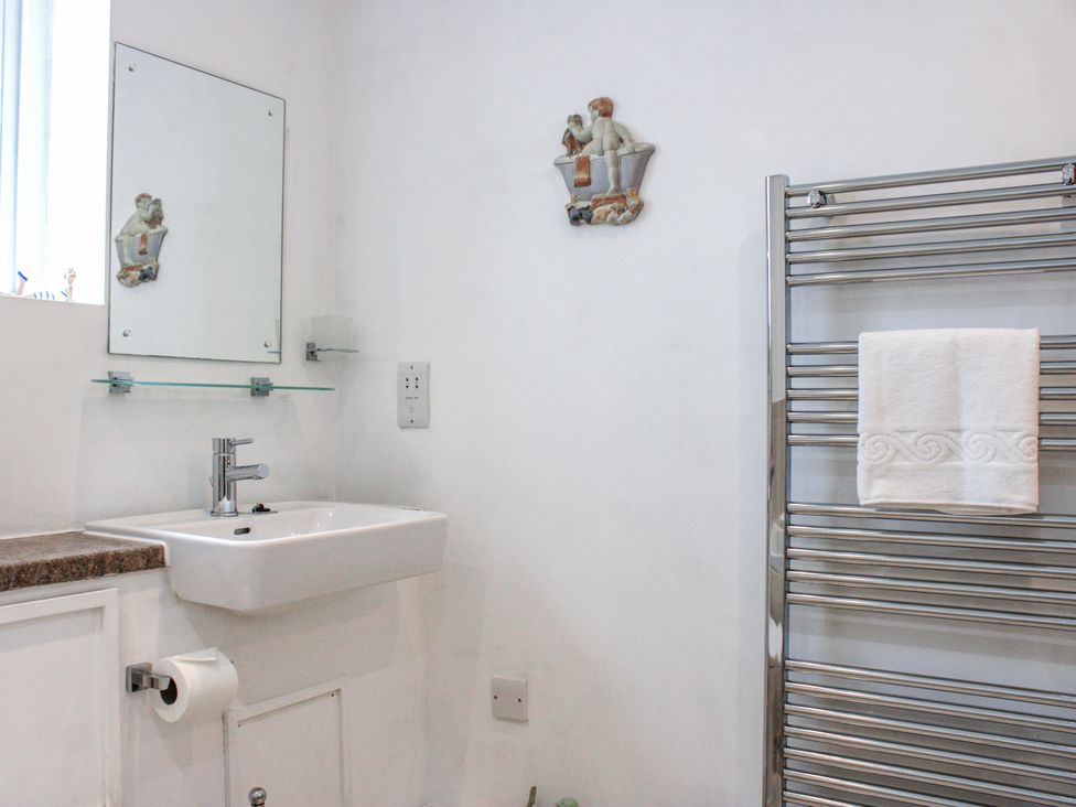 A bathroom with a sink and towel rail at Estuary View in Kingsbridge