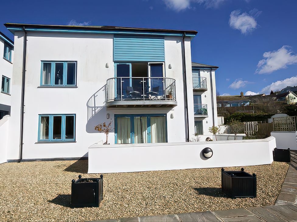 A building with a balcony and gravel area at Estuary View in Kingsbridge