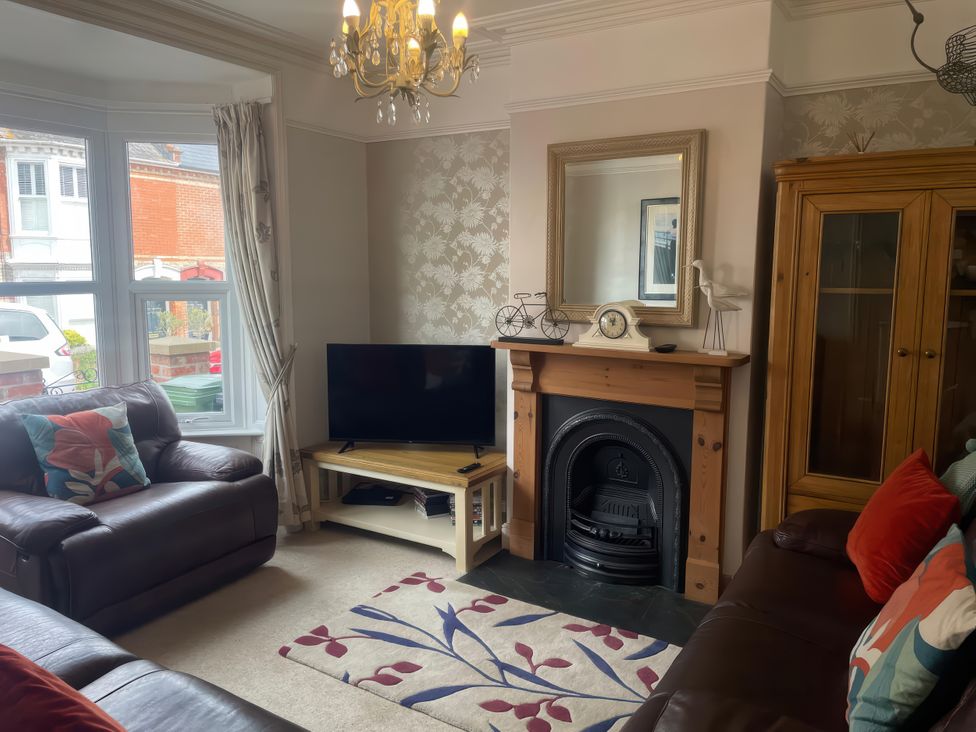 A living room with a television and sofa at Pedaller's Cottage in Weymouth