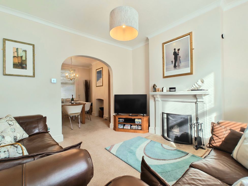 A living room with a sofa and television at Quay Cottage in Weymouth