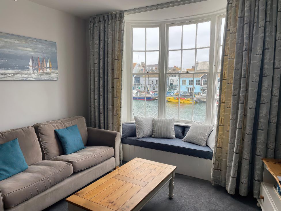 A living room with a sofa and coffee table at Safe Harbour in Brewers Quay harbour