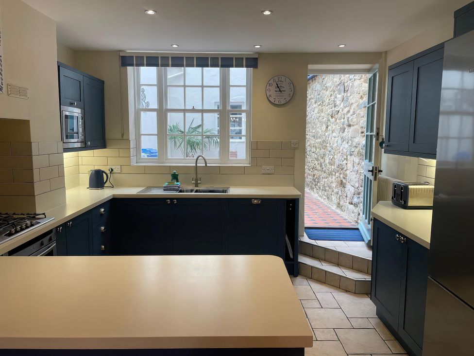 A kitchen with a sink and appliances at Safe Harbour in Brewers Quay harbour