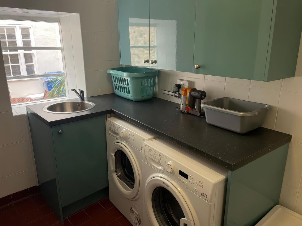 A laundry room with washing machine and dryer at Safe Harbour Brewers Quay harbour