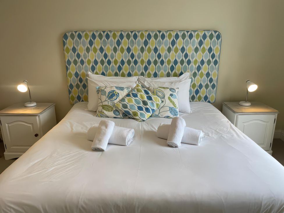A bedroom with a bed and decorative pillows at Safe Harbour in Brewers Quay harbour