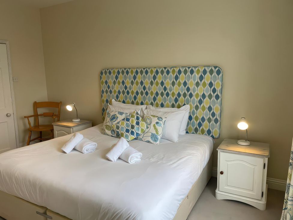 A bedroom with a bed and bedside tables at Safe Harbour Brewers Quay harbour