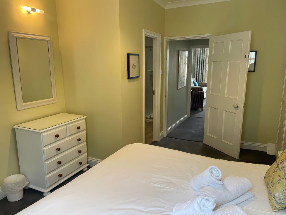 A bedroom with a bed and dresser at Safe Harbour in Brewers Quay harbour