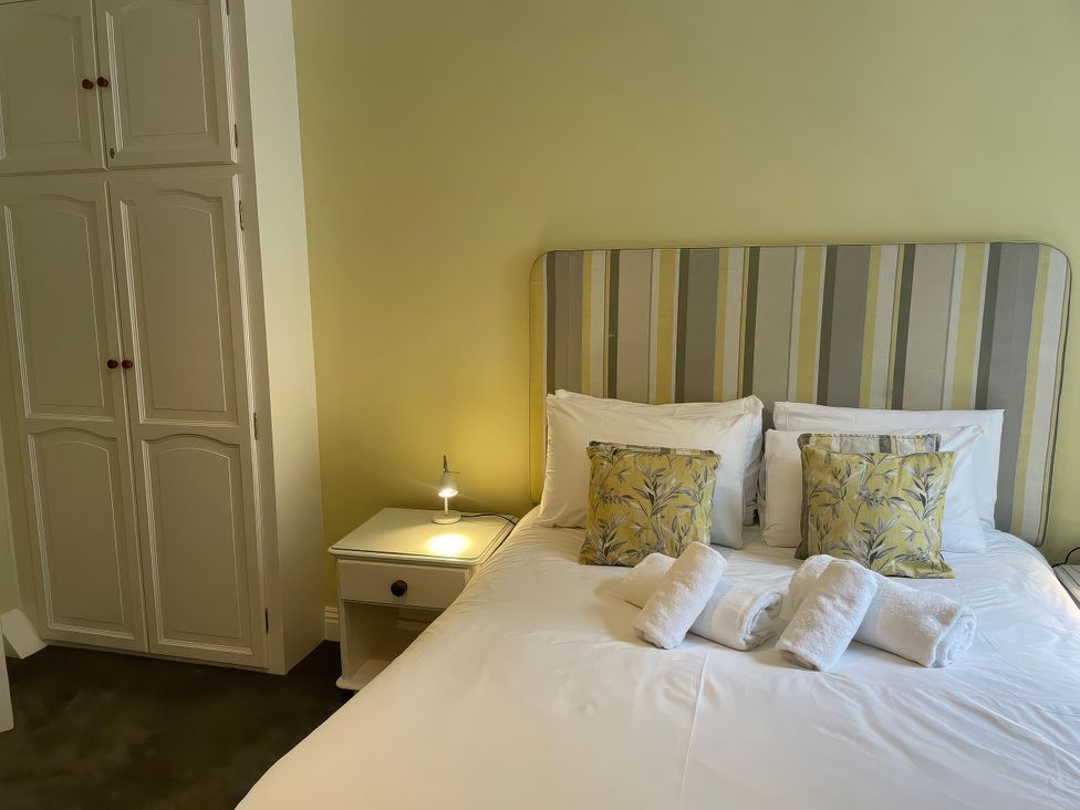 A bedroom with a bed and pillows at Safe Harbour, Brewers Quay harbour