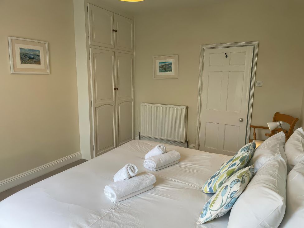 A bedroom with a bed and towels at Safe Harbour Brewers Quay harbour