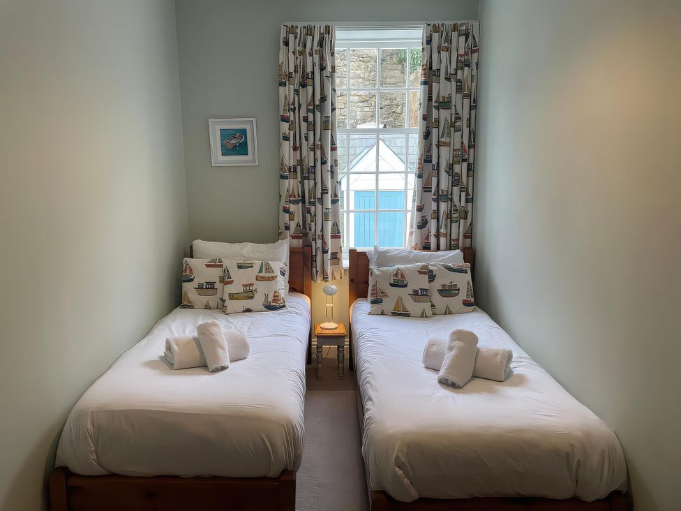 A bedroom with two single beds and a window at Safe Harbour in Brewers Quay harbour