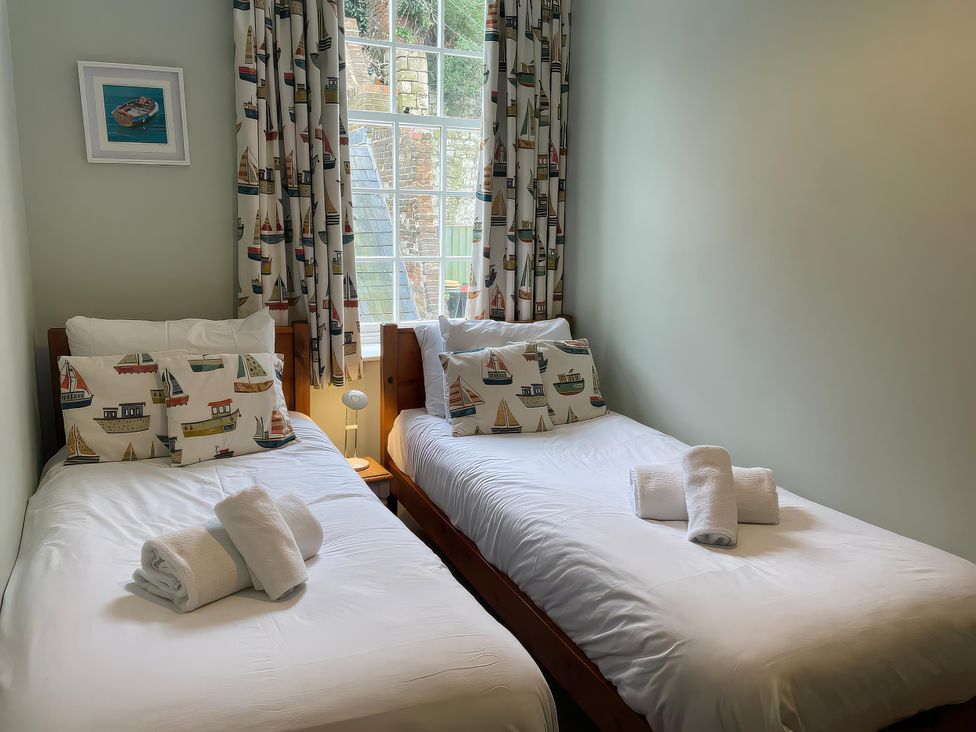 A bedroom with two beds and a window at Safe Harbour in Brewers Quay harbour