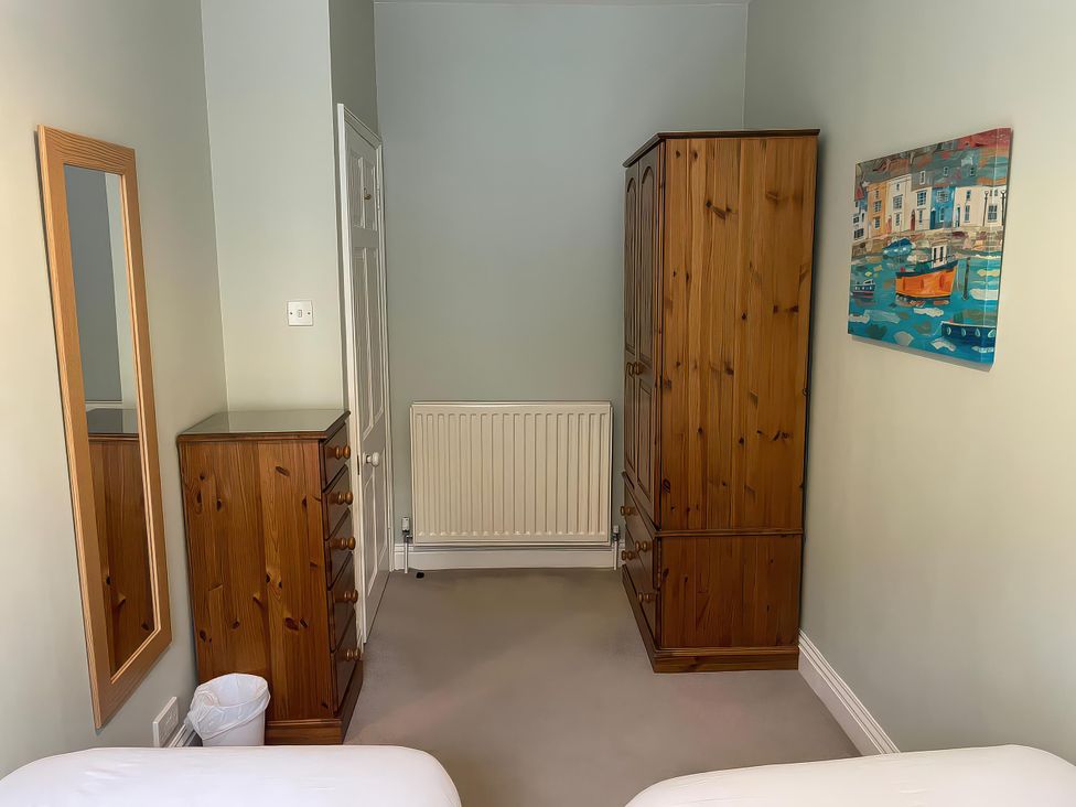 A bedroom with a wardrobe and chest of drawers at Safe Harbour in Brewers Quay harbour