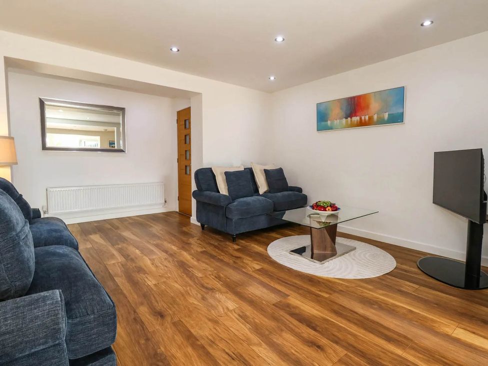 A living room with a sofa and a coffee table at Tides Corner in Bowleaze